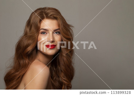 Nice young happy woman model with natural make-up, clean healthy fresh skin and long hair posing 113899328