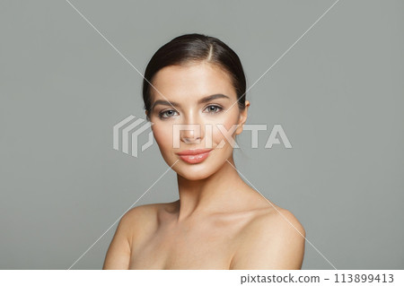 Gorgeous healthy model woman with beautiful skin and cute smile on white background, studio portrait Gorgeous healthy model woman with beautiful skin and cute smile on white background, studio portrait 113899413