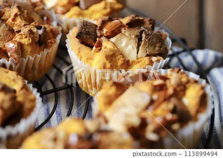 Pumpkin muffins filled with nuts and chocolate - homemade treats 113899494