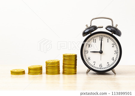 Alarm clock and toy gold coins Alarm clock and toy gold coins 113899501