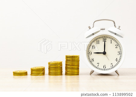 Alarm clock and toy gold coins Alarm clock and toy gold coins 113899502