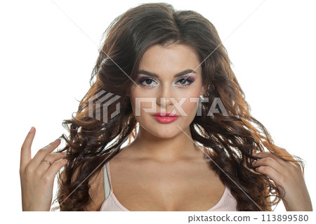 Cheerful fashion model with perfect clear skin, long curly hairstyle and make-up on white background 113899580
