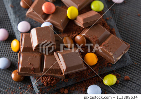 chocolate and skittles on a cocoa powder chocolate and skittles on a cocoa powder 113899634