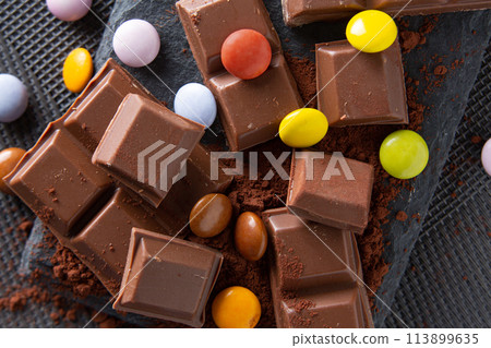 chocolate and skittles on a cocoa powder chocolate and skittles on a cocoa powder 113899635