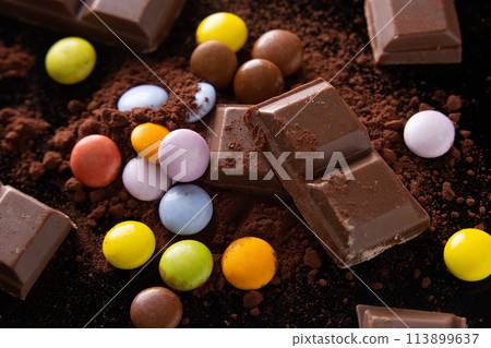 chocolate and skittles on a cocoa powder chocolate and skittles on a cocoa powder 113899637
