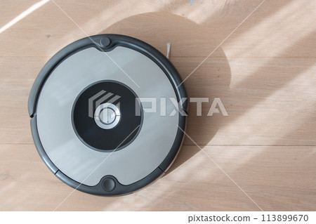 robot vacuum cleaner cleaning a wooden floor 113899670