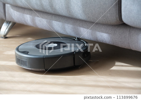 robot vacuum cleaner under a sofa. robot vacuum cleaner under a sofa. 113899676