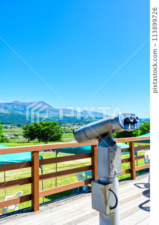 A telescope and Mount Aso can be seen from the observation deck with a clear spring sky as a backdrop. "Asobanosato Kugino Roadside Station" A telescope and Mount Aso can be seen from the observation deck with a clear spring sky as a backdrop. "Asobanosato Kugino Roadside Station" 113899726