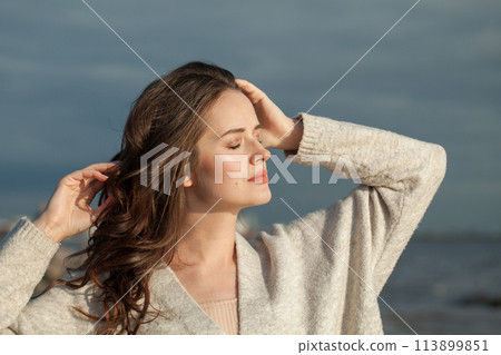 Happy brunette woman with fresh skin, natural make-up and healthy wavy brown hair  113899851