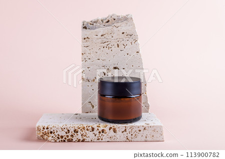 Amber glass jar mockup for moisturizer cream on marble podium on pastel pink background Amber glass jar mockup for moisturizer cream on marble podium on pastel pink background 113900782