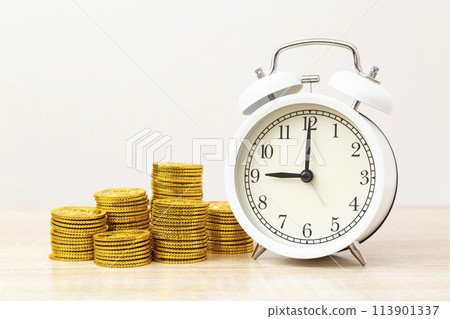 Alarm clock and toy gold coins 113901337