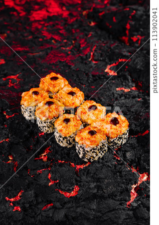 Spicy volcano sushi roll on lava textured background 113902041