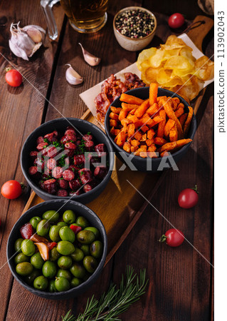 Assorted tapas platter with olives and snacks 113902043