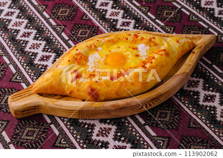 Traditional georgian khachapuri on wooden board Traditional georgian khachapuri on wooden board 113902062