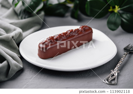 Elegant chocolate bar dessert on white plate Elegant chocolate bar dessert on white plate 113902118