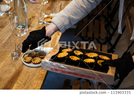 Caterer Arranging Gourmet Tartlets for Event Caterer Arranging Gourmet Tartlets for Event 113903335