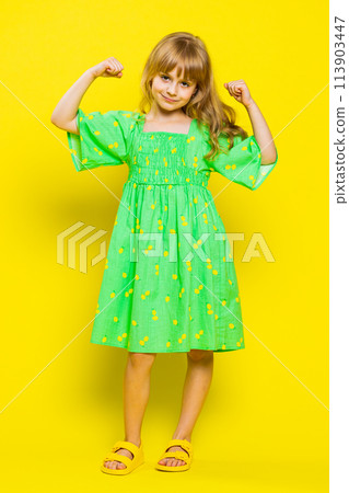 Fit sporty child girl kid showing biceps and looking healthy, feeling power strength success win 113903447