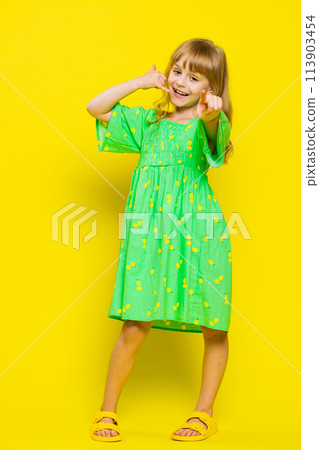 Child girl kid doing phone gesture like says hey you call me back advertising proposition, vertical Child girl kid doing phone gesture like says hey you call me back advertising proposition, vertical 113903454