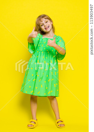 Happy preteen child girl kid looking approvingly at camera showing thumbs up, like positive sign 113903497