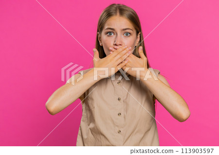 Frightened woman closing mouth with hands refusing to tell terrible secret, unbelievable truth Frightened woman closing mouth with hands refusing to tell terrible secret, unbelievable truth 113903597