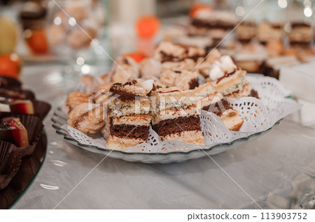 Sweet cakes at a wedding banquet. Catering, sweet festive buffet. Candy bar 113903752
