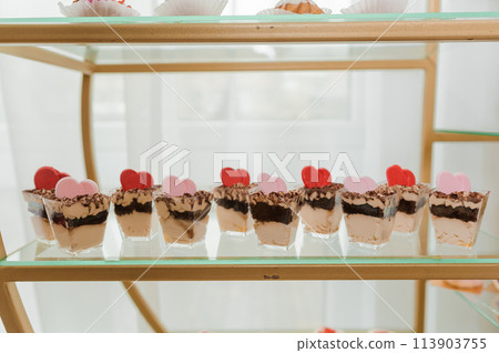 Sweet cakes at a wedding banquet. Catering, sweet festive buffet. Candy bar Sweet cakes at a wedding banquet. Catering, sweet festive buffet. Candy bar 113903755