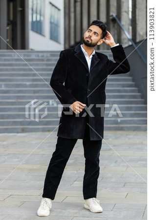 Strict business man looks to the side dreaming resting, good news feel satisfied stay in city street 113903821