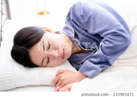 A young woman sleeping in bed A young woman sleeping in bed 113903872