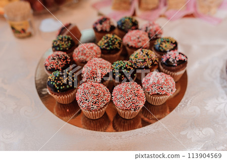 Sweet cakes at a wedding banquet. Catering, sweet festive buffet. Candy bar Sweet cakes at a wedding banquet. Catering, sweet festive buffet. Candy bar 113904569