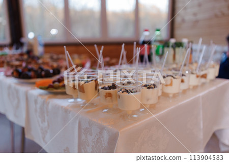 Sweet cakes at a wedding banquet. Catering, sweet festive buffet. Candy bar 113904583