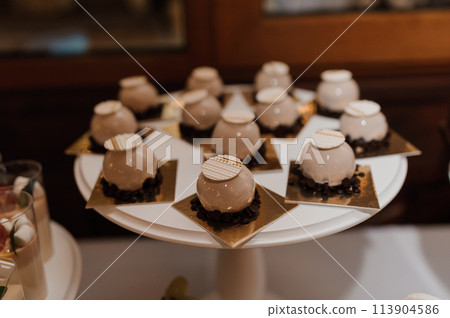 Sweet cakes at a wedding banquet. Catering, sweet festive buffet. Candy bar 113904586