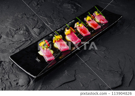 Gourmet tuna sashimi on black slate plate 113904826