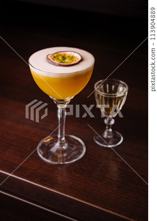 Elegant passion fruit cocktail with shot glass 113904889