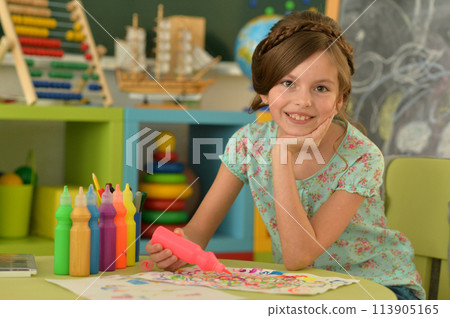 Portrait of cute girl drawing picture at home 113905165