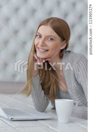 Portrait of a happy young girl with laptop computer Portrait of a happy young girl with laptop computer 113905174