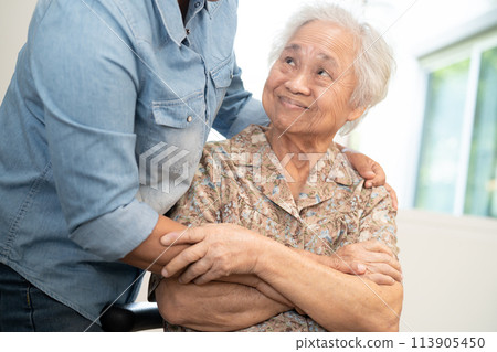 Asian elderly woman hug with her daughter with love, care, help, encourage and empathy. Asian elderly woman hug with her daughter with love, care, help, encourage and empathy. 113905450