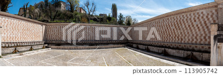Famous mediaeval Fountain of 99 Spouts in ithe old town of L'Aquila, Italy 113905742