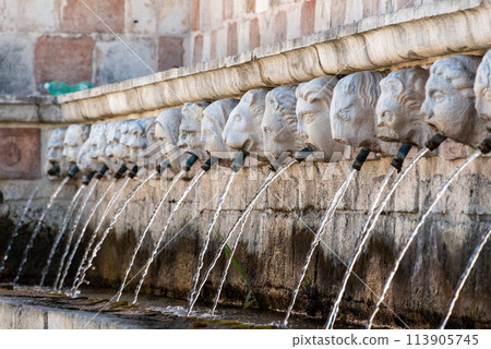 Famous mediaeval Fountain of 99 Spouts in ithe old town of L'Aquila, Italy 113905745