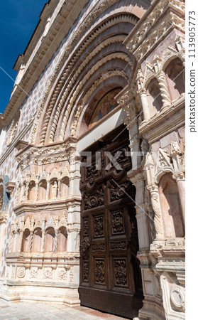 Ornate front gate of the rebuilt Romanesque basilica Santa Maria di Collemaggio in L'Aquila, Italy Ornate front gate of the rebuilt Romanesque basilica Santa Maria di Collemaggio in L'Aquila, Italy 113905773