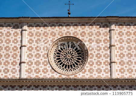 Typical Romanesque rose window of the portal of Basilica Santa Maria di Collemaggio in L'Aquila Typical Romanesque rose window of the portal of Basilica Santa Maria di Collemaggio in L'Aquila 113905775