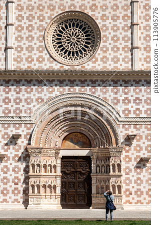 Typical Romanesque rose window of the portal of Basilica Santa Maria di Collemaggio in L'Aquila 113905776