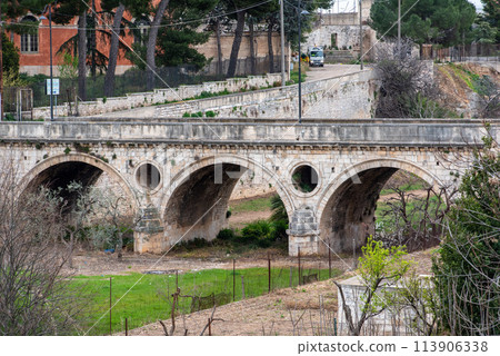 Beautiful old bridge with three arches in downtown Bitonto, Italy 113906338