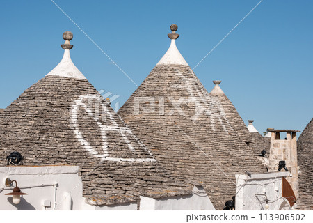 Iconic residential houses in historic Trulli district in Alberobello, Southern Italy 113906502