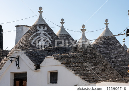 Iconic residential houses in historic Trulli district in Alberobello, Southern Italy Iconic residential houses in historic Trulli district in Alberobello, Southern Italy 113906748