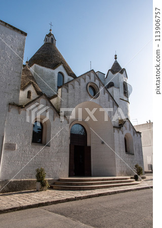 Famous Trullo shaped church Sant'Antonio di Padova in Alberobello, Southern Italy 113906757