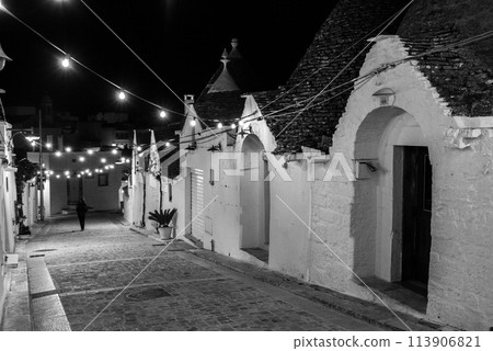 Scenic abandoned street in the Trulli district of Alberobello, Italy 113906821