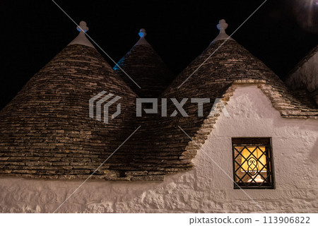 Scenic abandoned street in the Trulli district of Alberobello at night, Italy Scenic abandoned street in the Trulli district of Alberobello at night, Italy 113906822