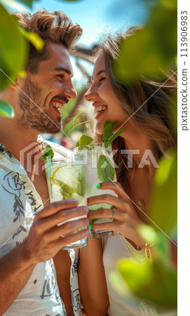 Young people on vacation drinking a refreshing Mojito, summer vacation 113906983