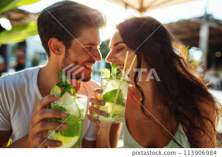 Young people on vacation drinking a refreshing Mojito, summer vacation 113906984
