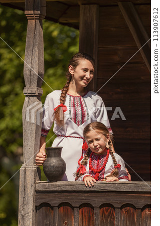 mother and daughter dressed in Ukrainian national costumes mother and daughter dressed in Ukrainian national costumes 113907612